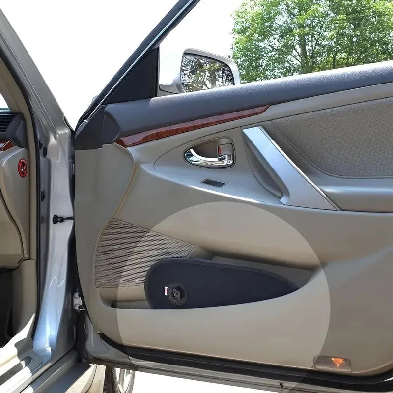 Black stretchy car side window shade installed with suction cups to protect baby from sun.