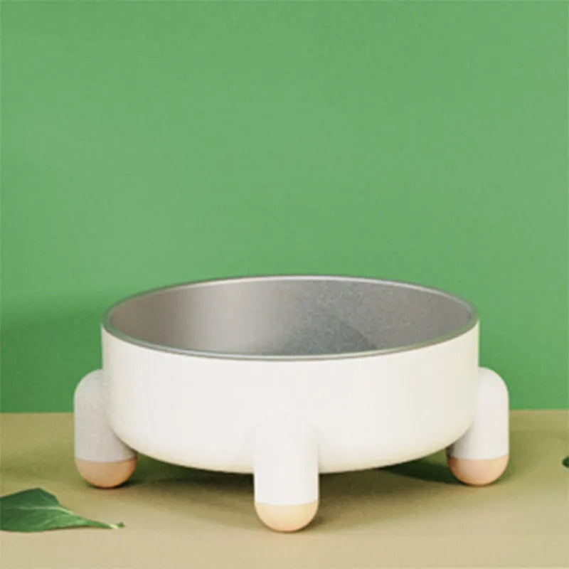 Green stainless steel pet bowl with non-slip base and high foot on a kitchen floor