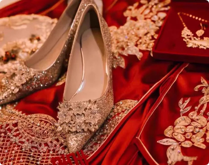 Champagne coloured bridal shoes with pointed toe, fine heel, and rhinestone floral decoration.