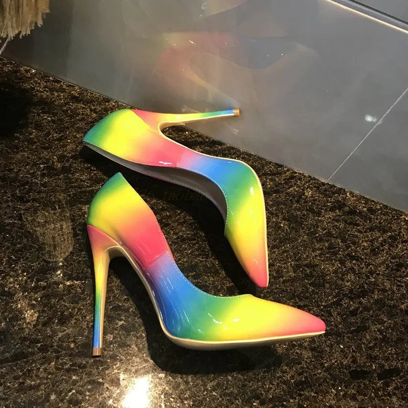 Rainbow coloured patent leather women's high heel shoe with pointed toe and thin high heel.