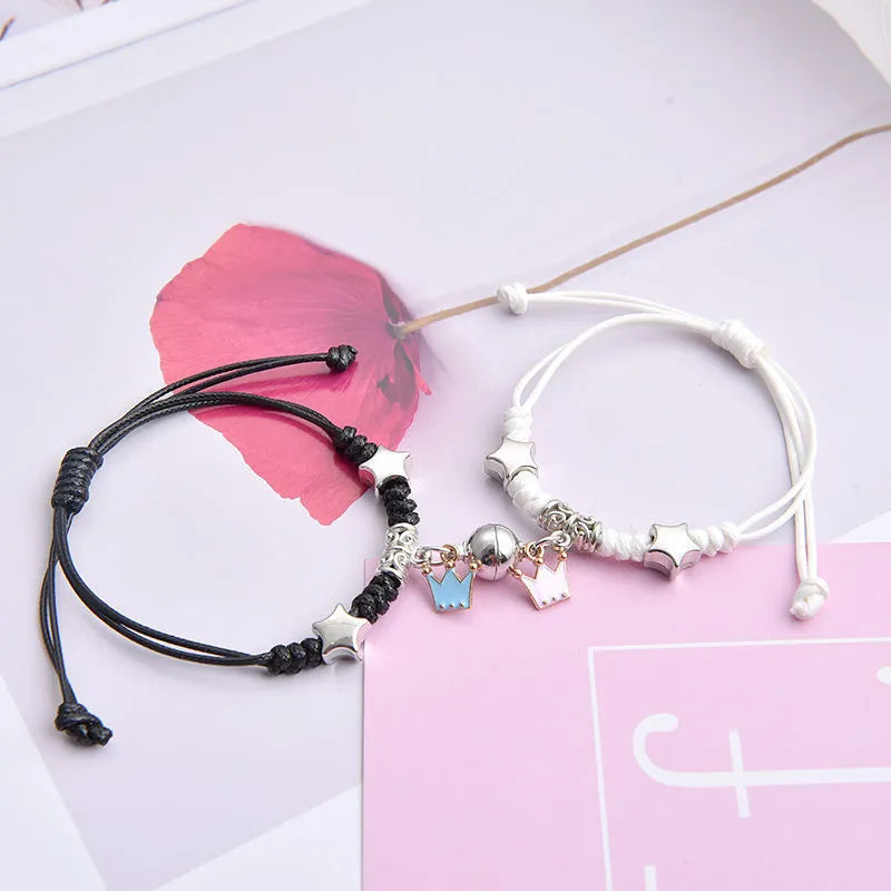 Alloy couple bracelets with magnet closure showing various design options including crown, clover, and text patterns