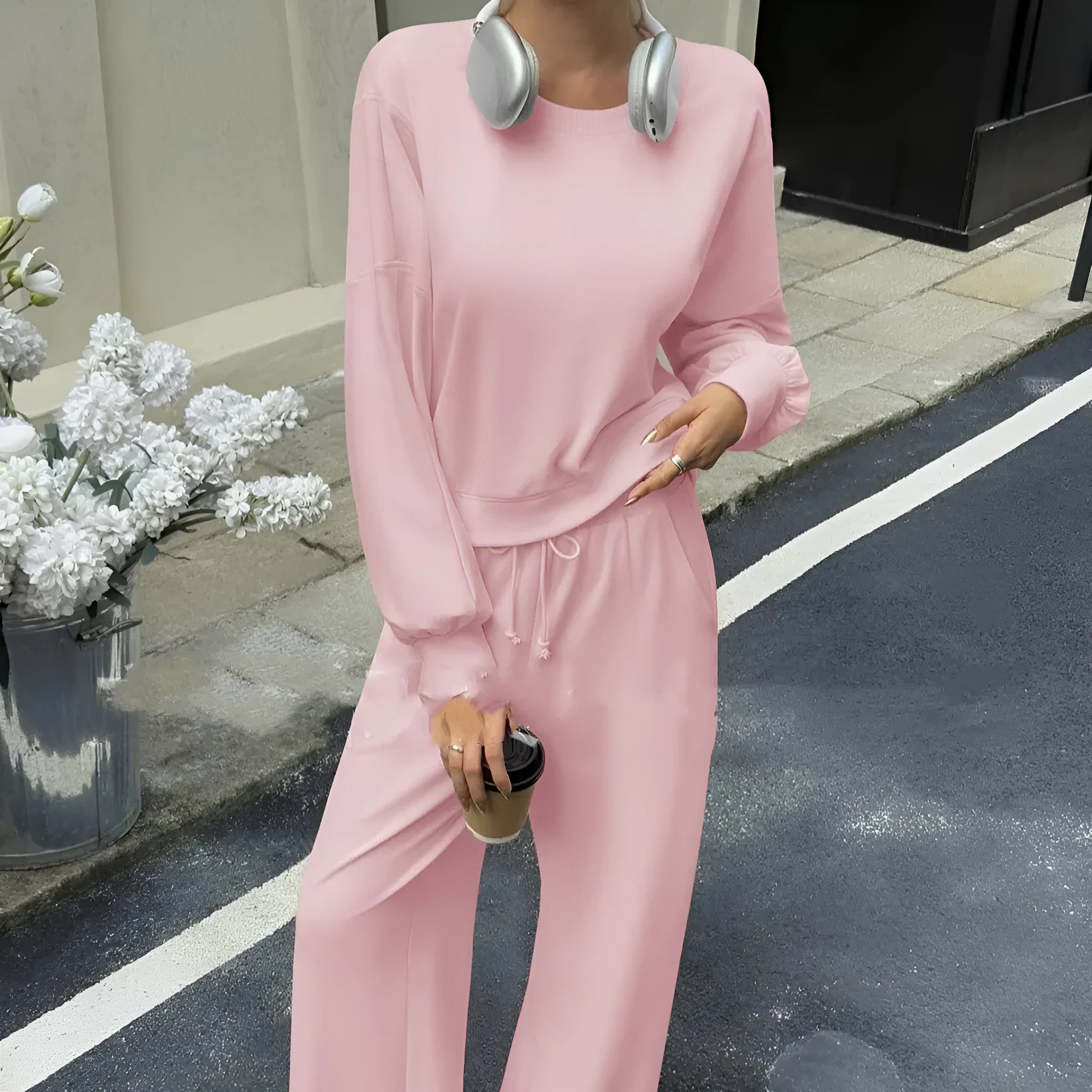 Women's solid colour long sleeve top and trousers two-piece set in polyester fabric.
