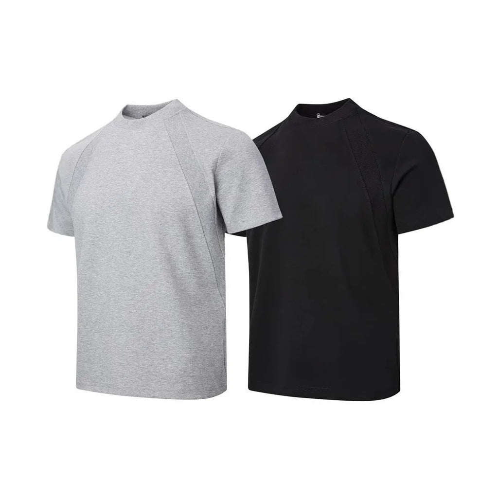 Man wearing a black loose-fit short sleeve top with visible air layer stitching texture.