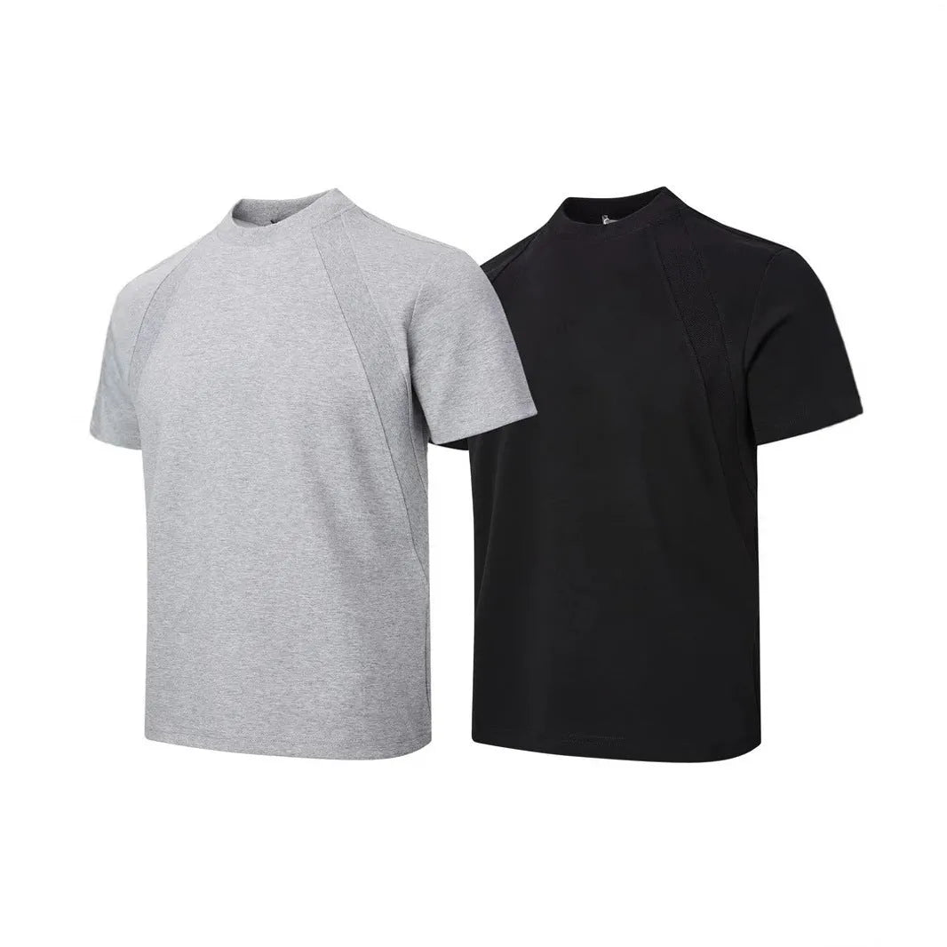 Man wearing a black loose-fit short sleeve top with visible air layer stitching texture.