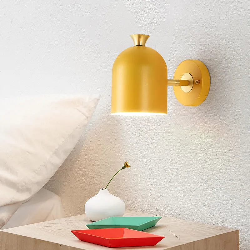 Blue aluminium single-head LED wall lamp mounted beside a bed.