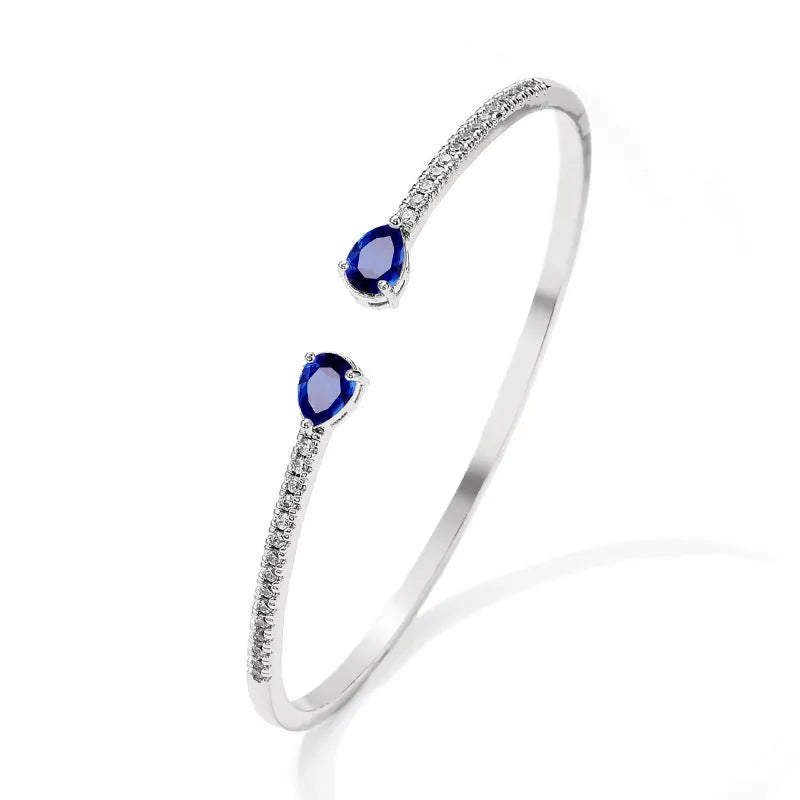 Copper bracelet with inlaid white zircon crystals on a simple band.