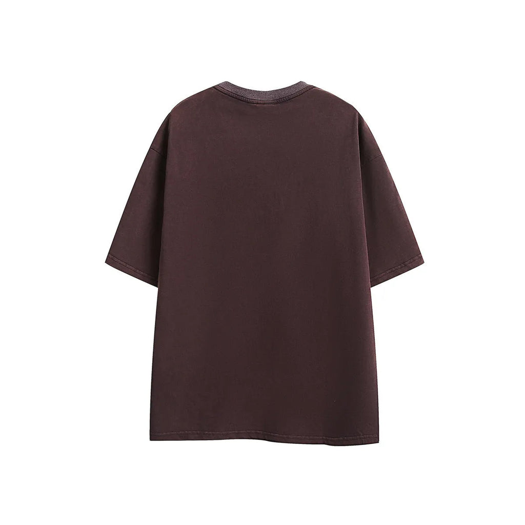 Purple loose-fit cotton t-shirt with embroidered detailing and a washed retro look on a hanger.