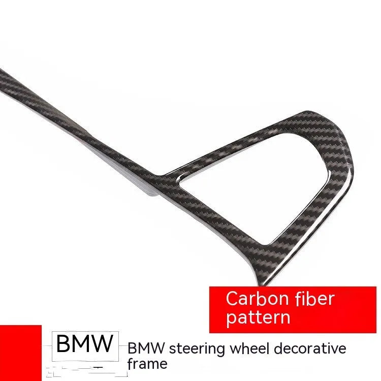 BMW steering wheel button frame decoration in black carbon fibre pattern.
