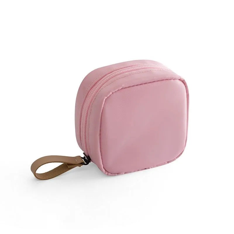 Cloth cube-shaped makeup storage bag shown in blue, pink, white, and white pink colour options.