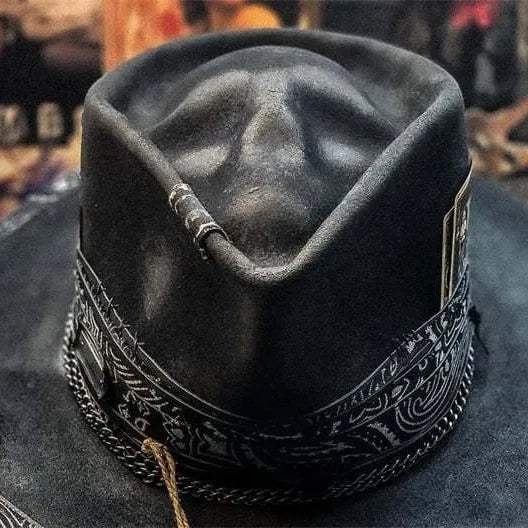 Handmade wool felt Halloween hat with a pointed conical crown in a skull design.