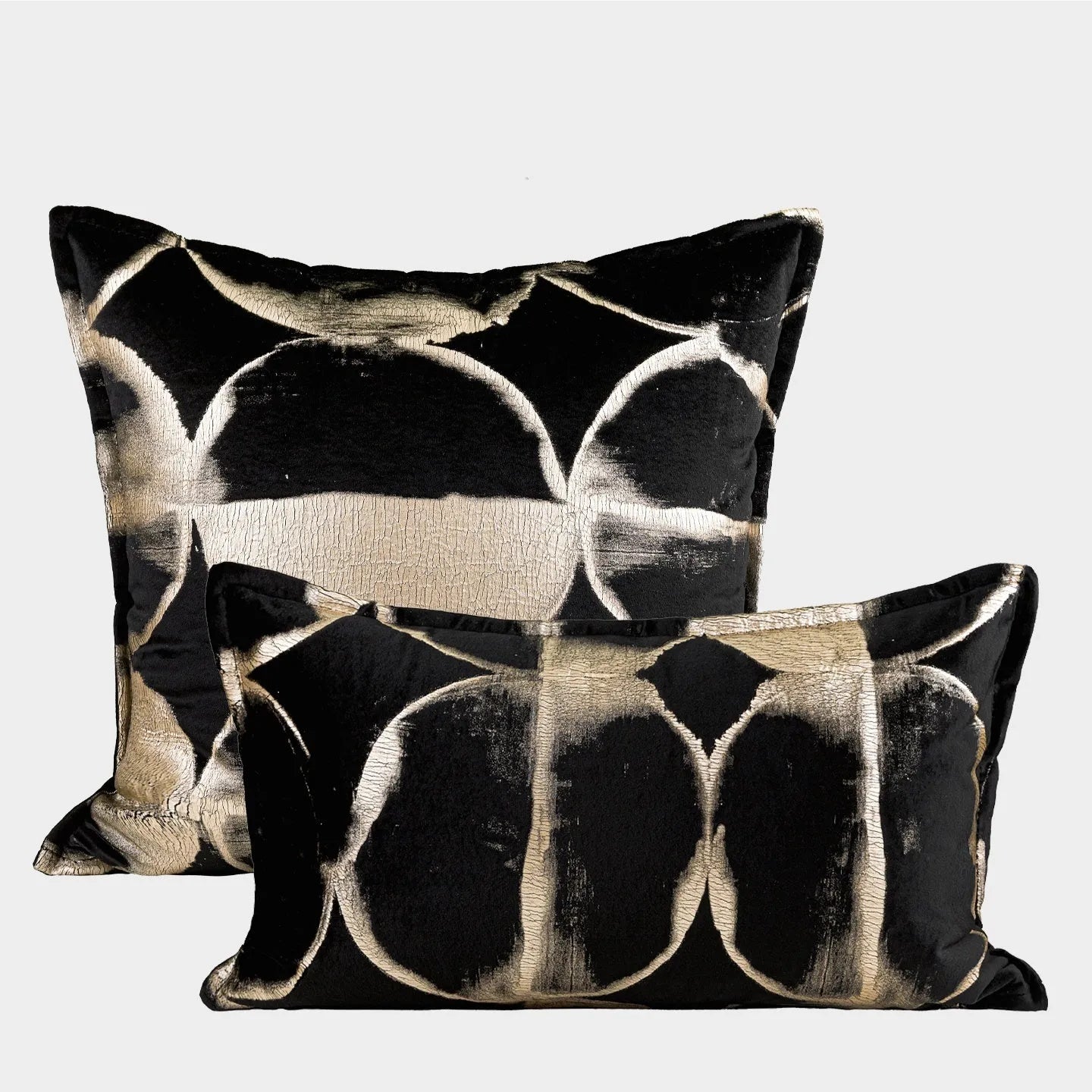 Black and gold abstract patterned decorative cushion on a sofa, available in three sizes with a removable cover.