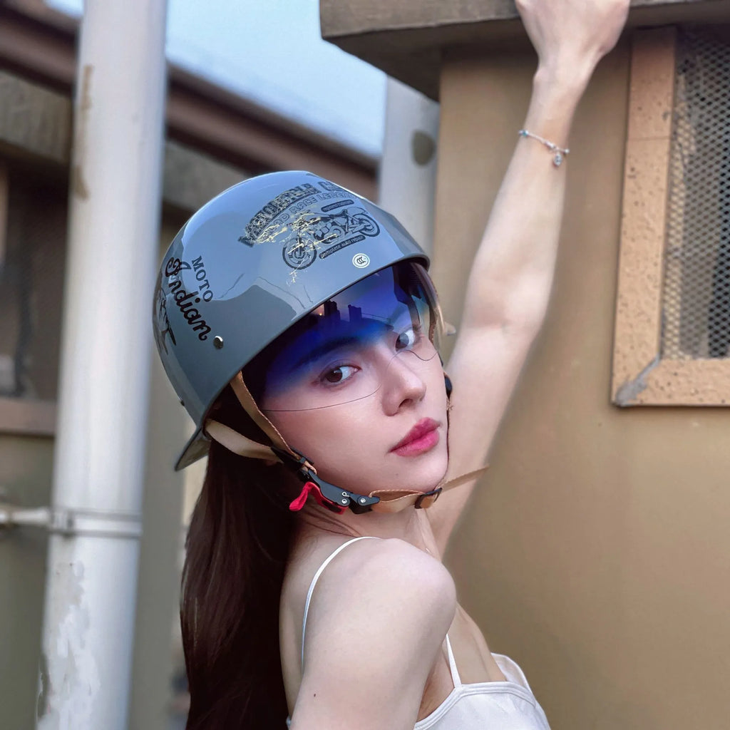 Retro-style half helmet for electric bicycles in bright black with a gradient blue tinted lens.