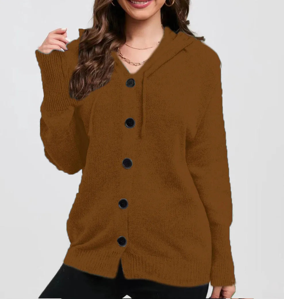 Woman wearing a thick, loose-fit grey hooded cardigan sweater with long sleeves.
