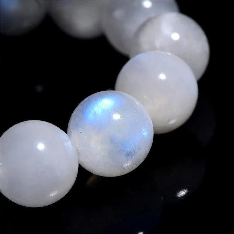 Natural blue moonlight moonstone round bead bracelet showing polished geometric beads on wrist