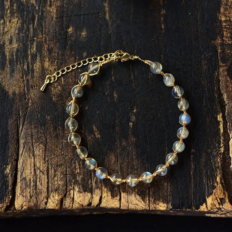 Women's blue moonstone bracelet with 6mm crystals in 14K gilded setting featuring starry sky design