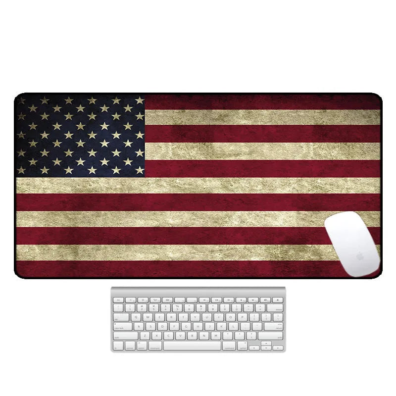 Large printed desk mat with natural rubber non-slip base on a wooden desk with keyboard and mouse.