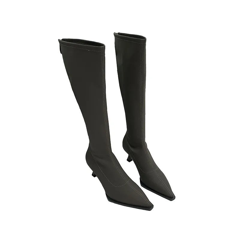 Women's black pointed toe stiletto heel boots with a back zip, shown from the side.