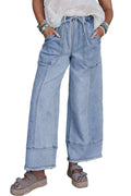 Beau blue wide leg denim trousers with a drawstring waist and raw hem on a hanger