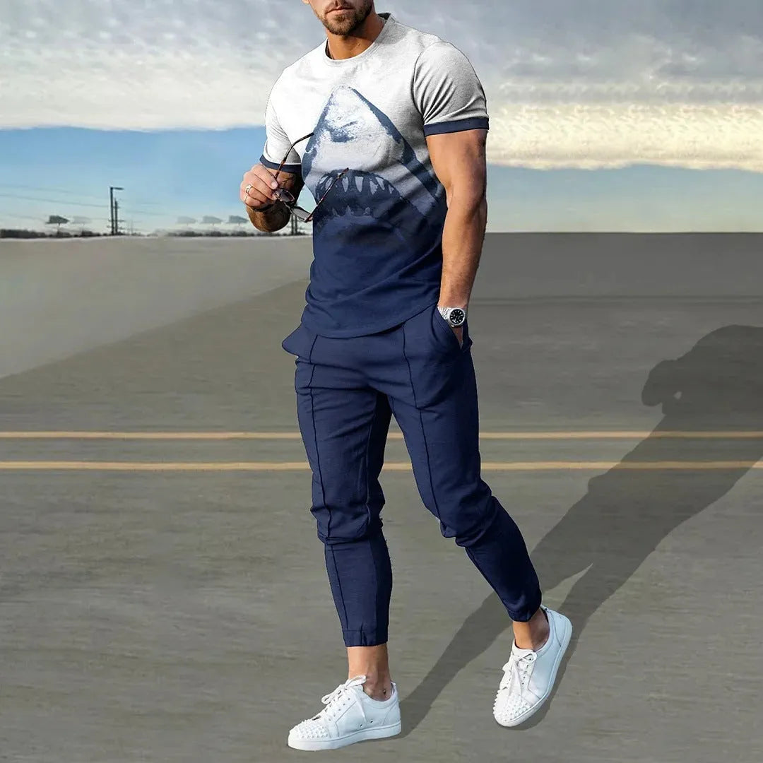 Man wearing a printed short-sleeve t-shirt and matching trousers from a cotton-like men's tracksuit set.