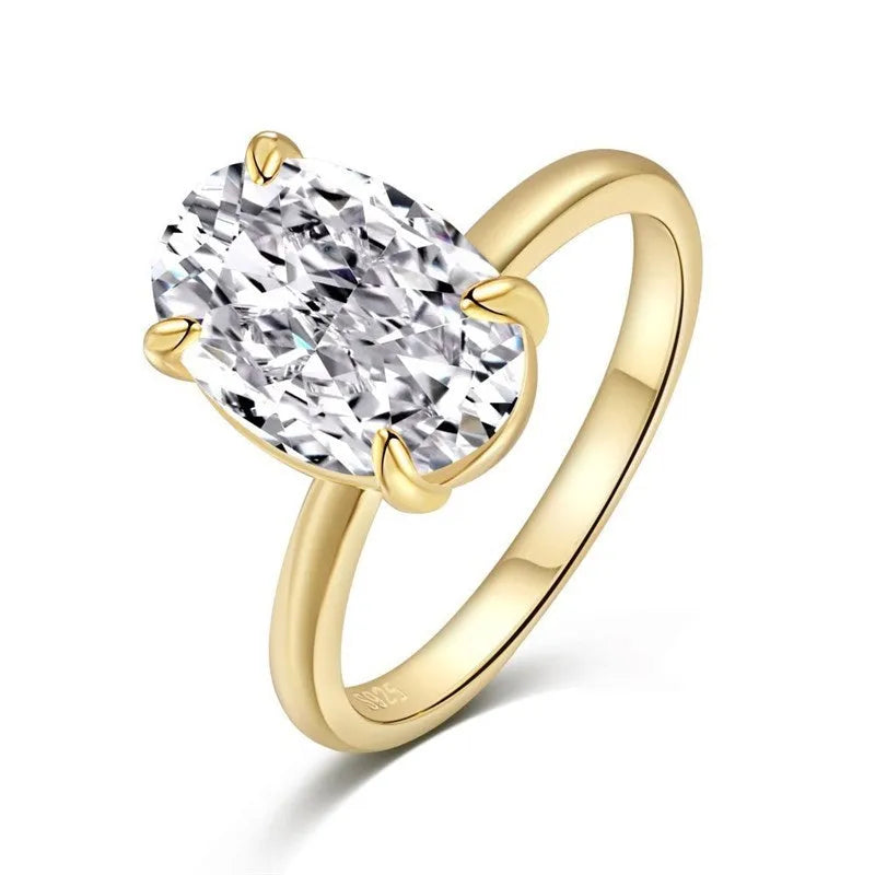 Oval women's ring with four-claw setting holding 6x9mm gemstone in gold or silver finish