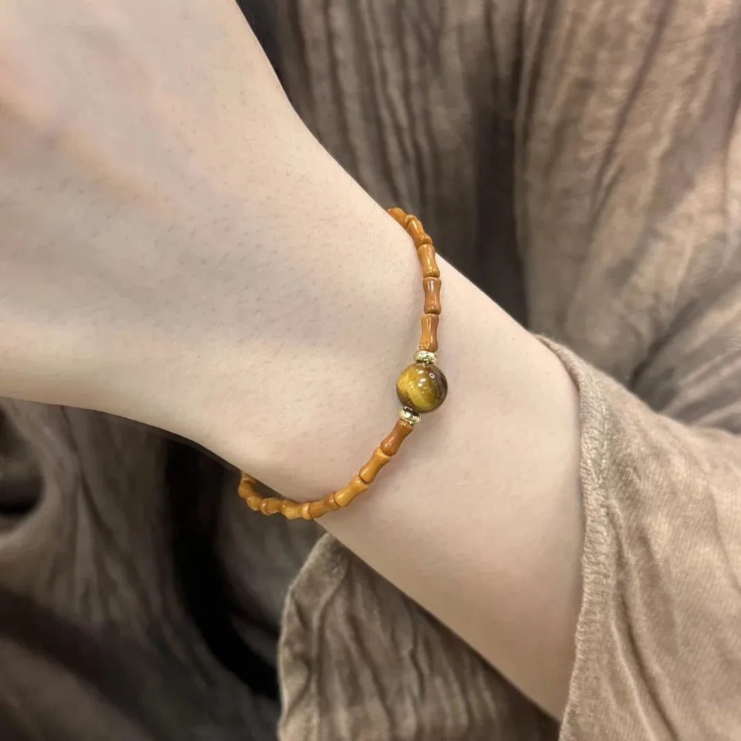Natural yellow tiger's eye and Hetian jade bracelet with U-shaped bead design showing golden gourd pattern