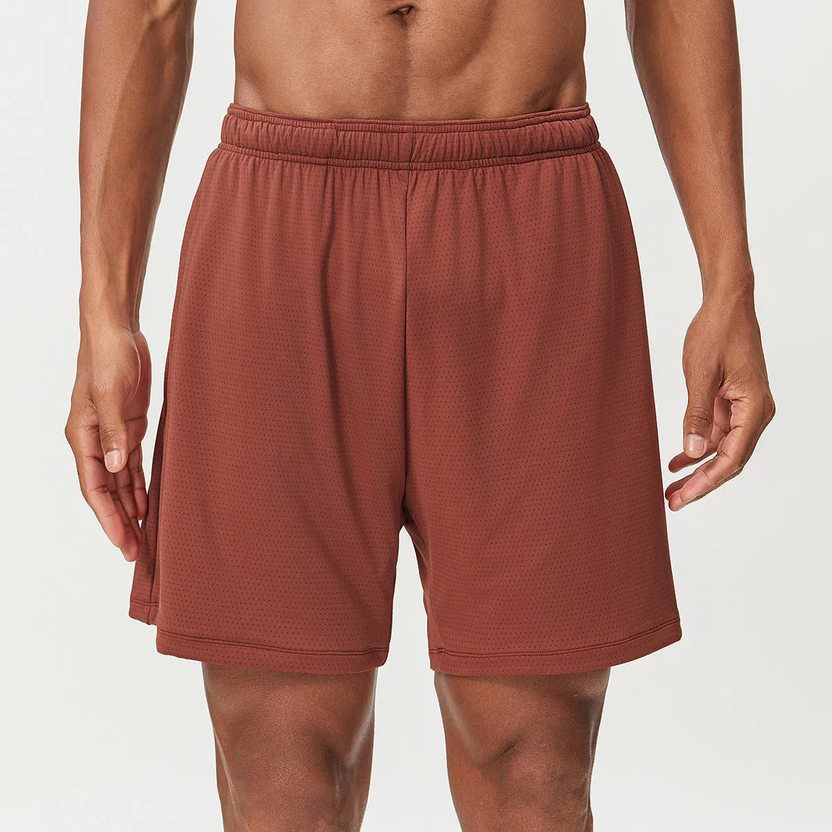 Man's quick-drying athletic shorts in khaki colour, showing double-layer construction and mid-waist fit.