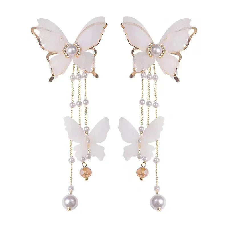 White butterfly earrings with lace patterns, rhinestones, pearls and tassel drops
