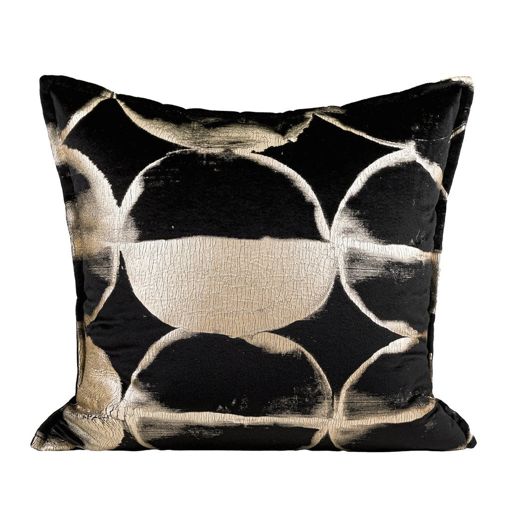 Black and gold abstract patterned decorative cushion on a sofa, available in three sizes with a removable cover.
