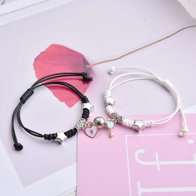 Alloy couple bracelets with magnet closure showing various design options including crown, clover, and text patterns