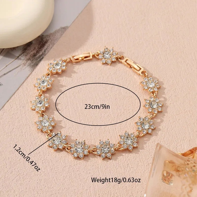 Electroplated zinc alloy flower bracelet in a choice of gold or silver finishes with coloured gemstone designs.