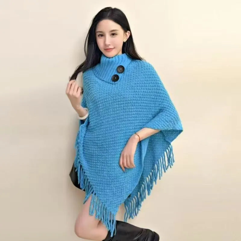 Women's triangular plush shawl cape with tassels in a cashmere and acrylic blend fabric.