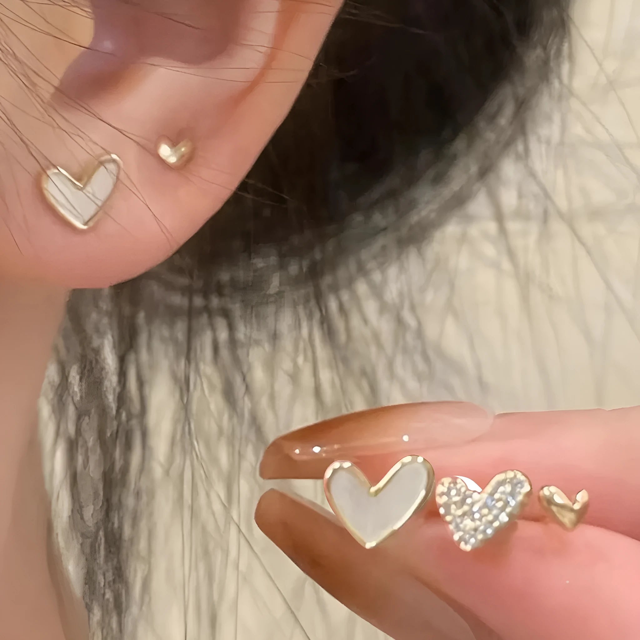 Three pairs of heart shape alloy earrings with electroplated gold, black, pink, and black-white colour options