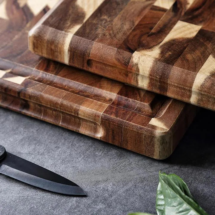 Brown acacia wood parquet cutting board with 3cm thickness on kitchen counter