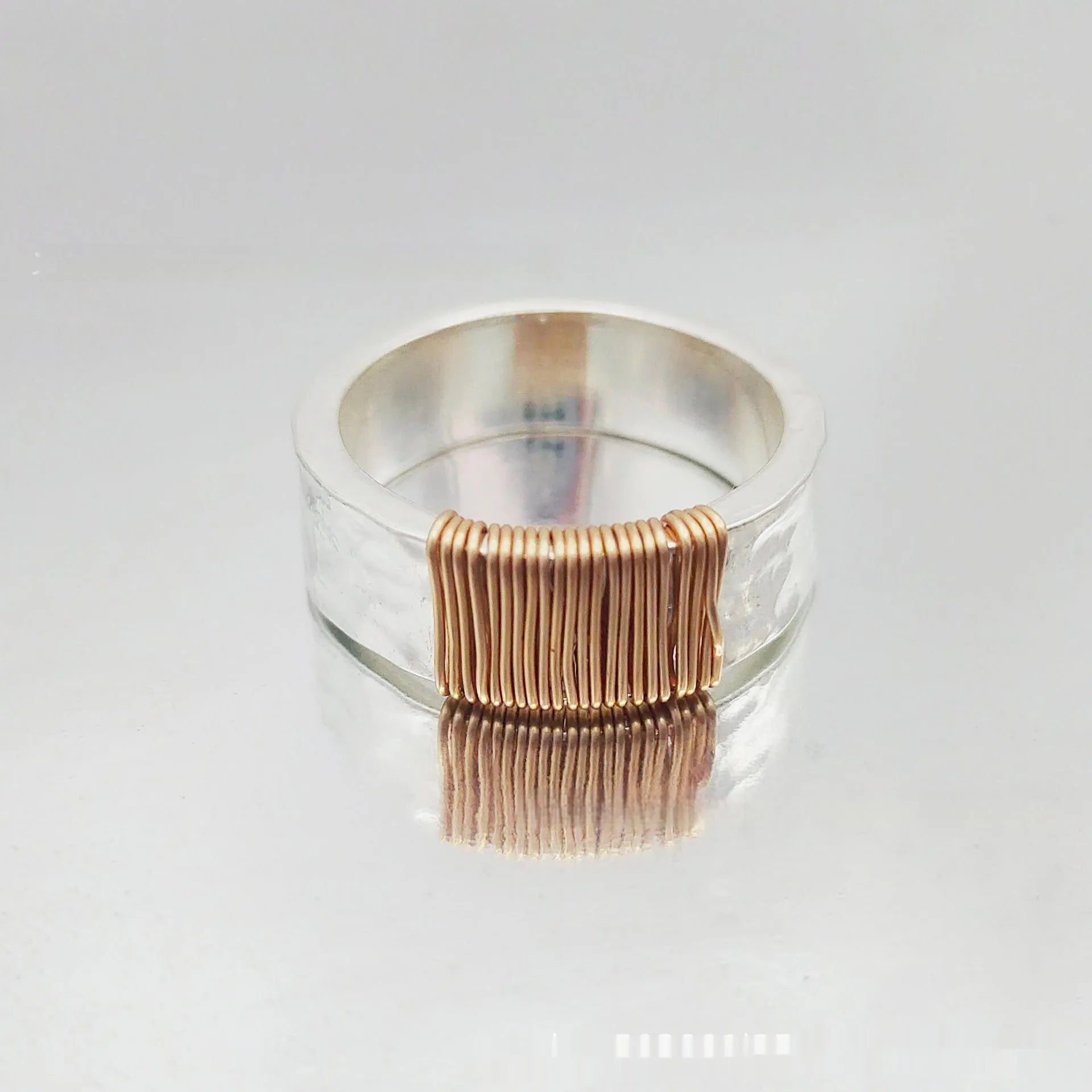 Wide-faced copper geometric bracelet with silver gold electroplated coil finish