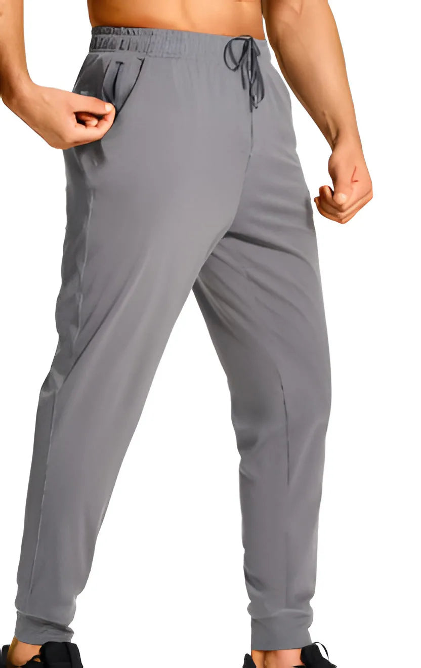 Men's loose-fit solid colour casual trousers on a hanger, showing the relaxed leg cut.