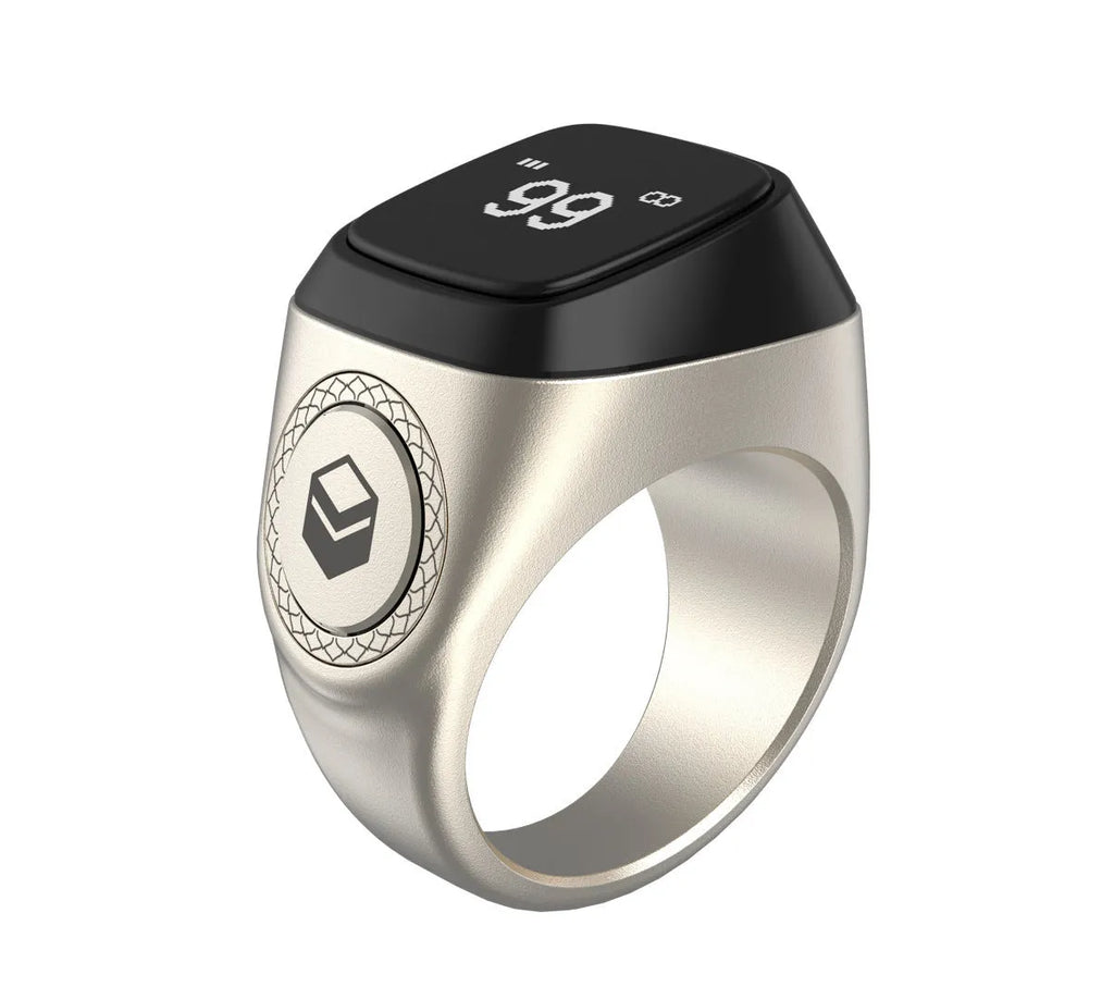 Zikr1 Lite Tasbih smart ring in silver on a charging case with USB cable.