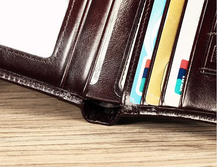Men's leather wallet showing multiple internal compartments including card slots, coin pocket and photo window