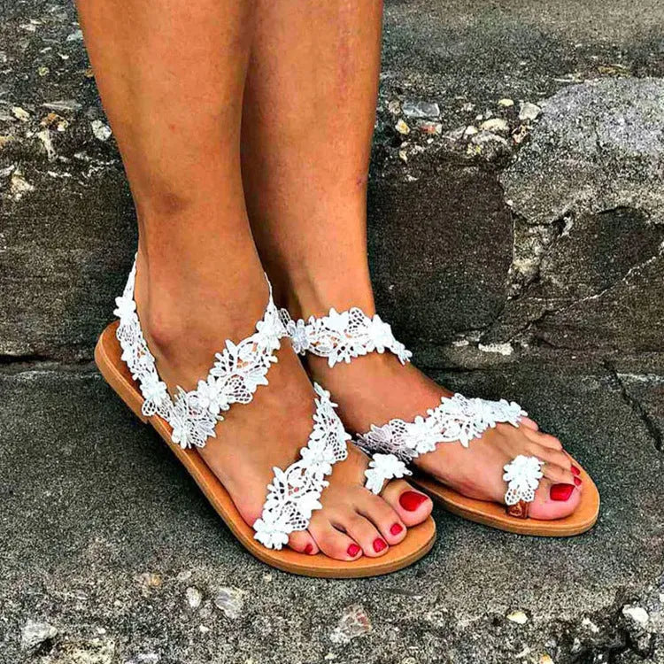 White plus size women's flat shoes with rhinestone and flower decoration on the upper.