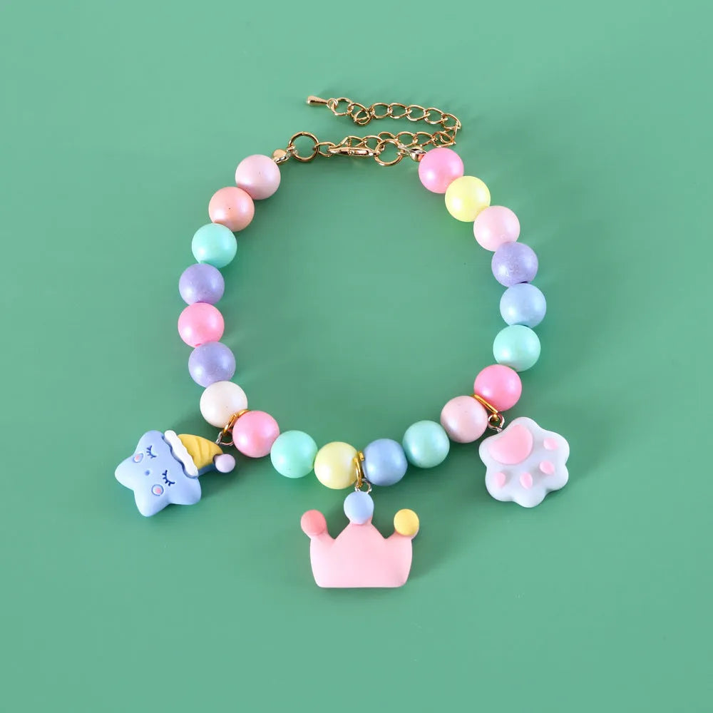 Macaron-colour pet collar with moon and pearl resin charms and a matching bracelet.