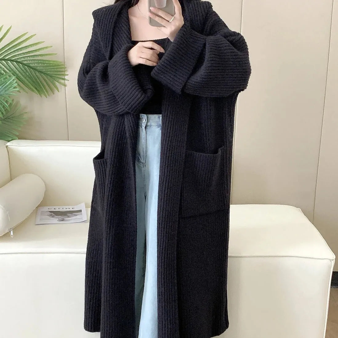 Loose hooded acrylic cardigan sweatshirt in milky white colour showing raglan sleeves and 80cm length