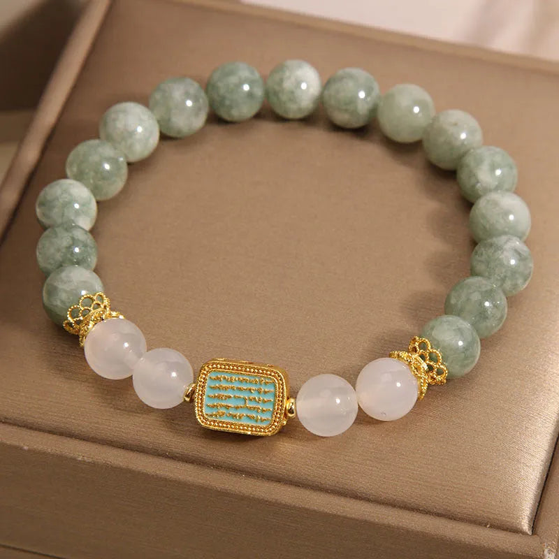 Oil green emerald crystal bracelet for women with five scripture charms on a white background.
