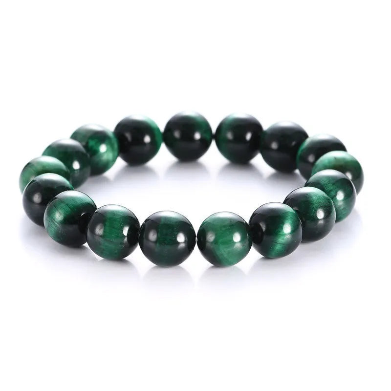 Green tiger eye stone bracelet with geometric beads on a wrist