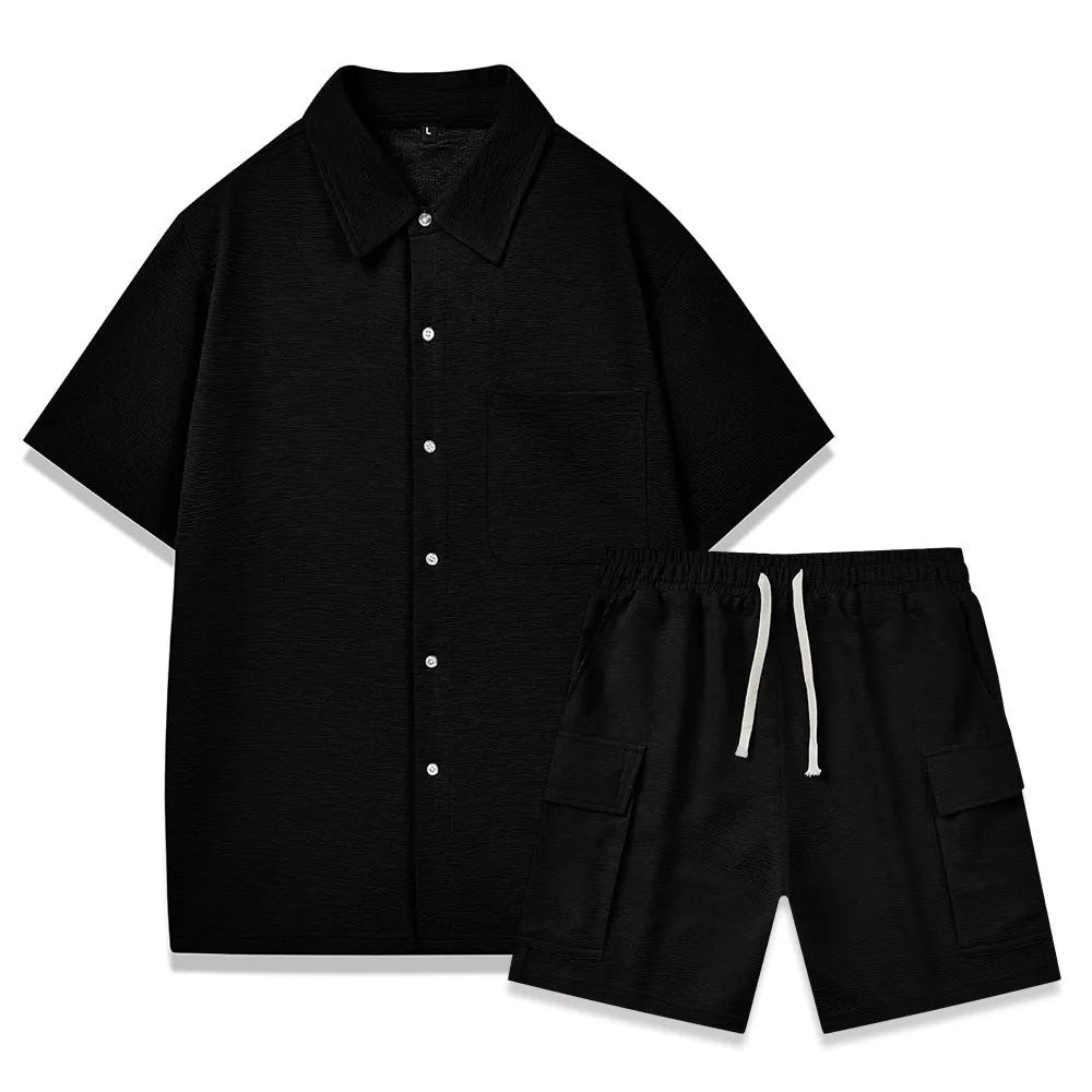 Women's black polyester two-piece set with short sleeve top and elastic waist shorts laid flat.