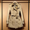 Khaki women's trench coat with double-breasted button front and flight sleeves