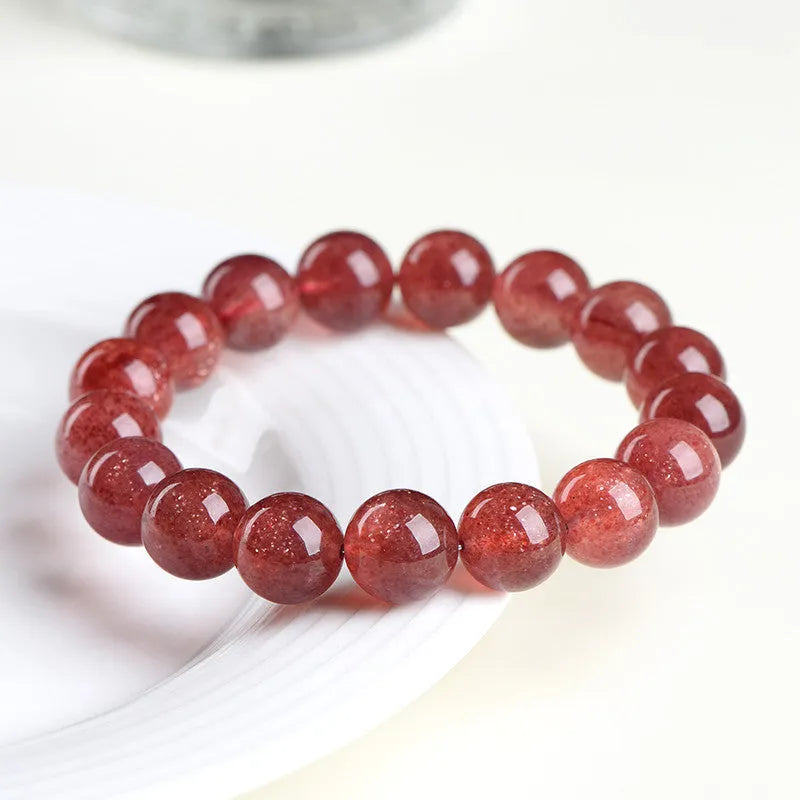 A bracelet made of geometrically cut, pink strawberry quartz beads in three size options.