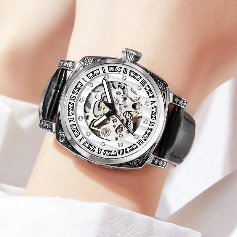 Leather strap mechanical watch with luminous hands on a wrist, showing black dial variant.