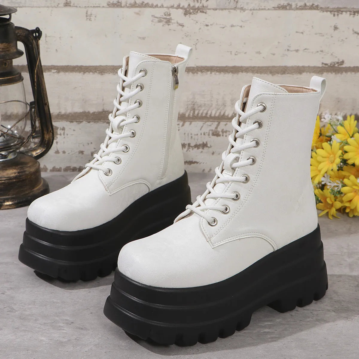 Women's black patchwork platform Martin boots with a chunky heel and side zipper.