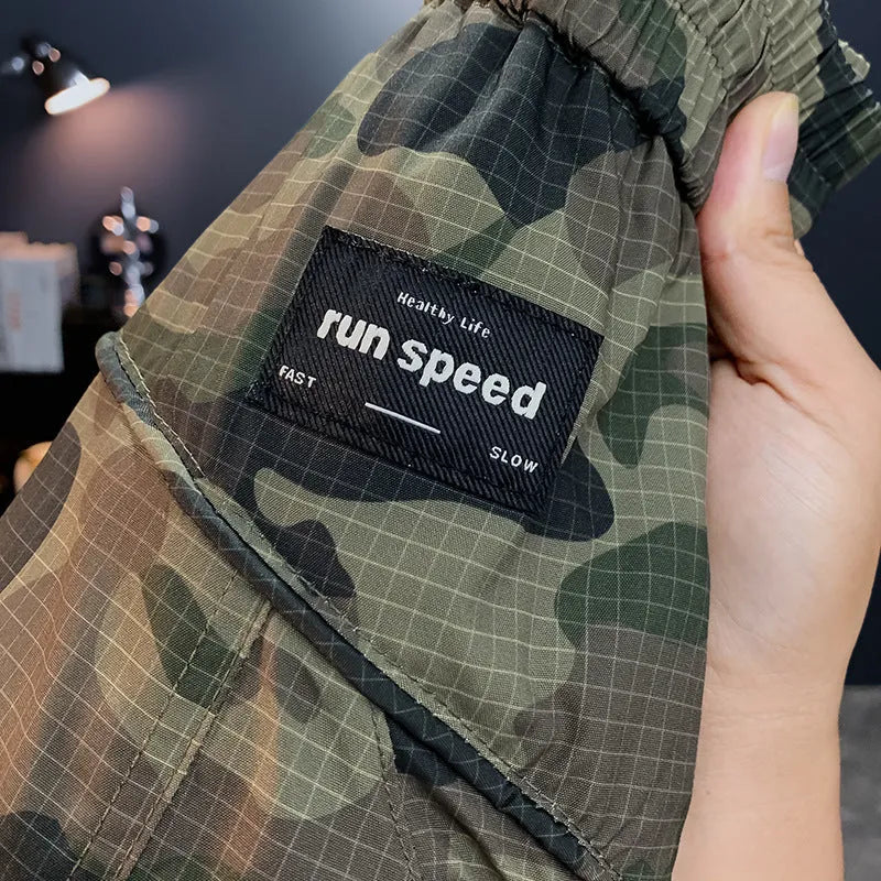 Men's camouflage cargo shorts in a loose fit with multiple pockets, shown in camouflage pattern.