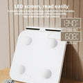 White professional body fat scale with 8 electrodes and tempered glass platform, showing LED display.