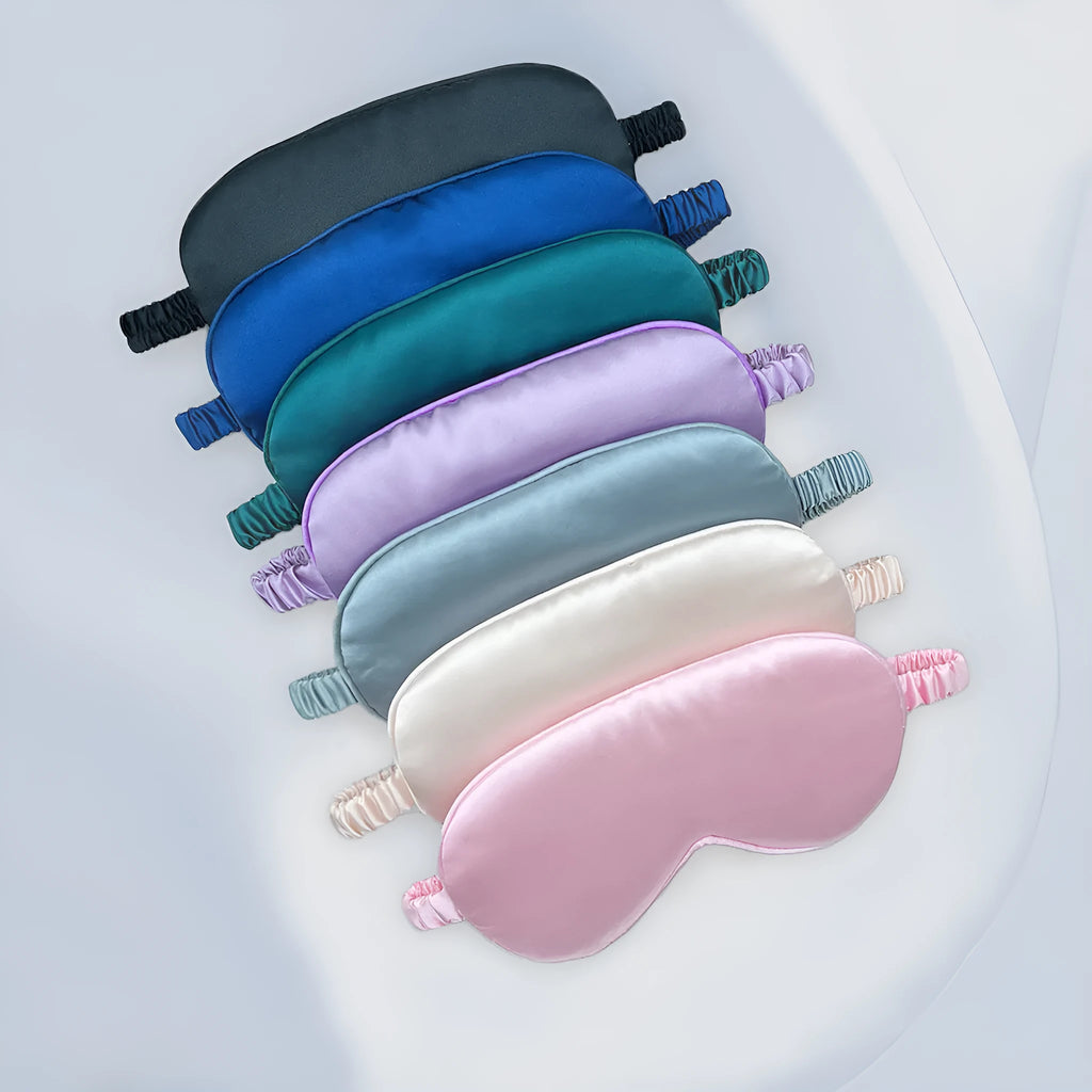 Double-sided Rayon elastic satin sleep mask shown in multiple colour options including sky blue, black, wine red, and light pink.